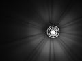 Geometric chandelier with light bulb produces an interesting shade with copy space. Black and white photo with illumination. Home