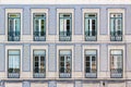 Facade of an ordinary house in Lisbon decorated with traditional ornamental azulejo tiles