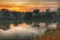 Geometric constriction in lake water under the morning orange coloured sky