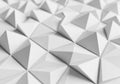 Geometric 3D pattern featuring an array of white pyramidal shapes arranged Royalty Free Stock Photo
