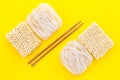 Geometric design with Chinese, Japanese products, noodles, rice vermicelli, sticks on yellow background top view