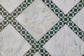 Geometric green tiles on marble floor