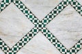 Geometric green tiles in diamond pattern on marble floor