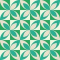 Mid century modern white and mint green geometric leaves seamless pattern on dark green squares.