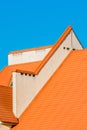 Geometric modern building facade exterior with orange tiled roof. Hotel against a blue sky Royalty Free Stock Photo