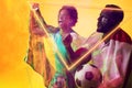 Geometric neon over african american fans with flags celebrating success during soccer match