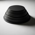 A geometric object resembling a black conical frustum is displayed on Royalty Free Stock Photo