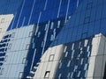 Geometric pattern background of glass wall of office building reflecting another office building in Bucharest Royalty Free Stock Photo