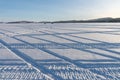 Geometric pattern from car tracks on the snowy surface of the Big Lake. Royalty Free Stock Photo