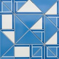 Geometric pattern featuring blue and white tiles arranged in a symmetrical design. Each tile Royalty Free Stock Photo