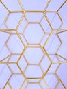 Geometric pattern of hexagons made of metal in gold color on a purple background. Concept background, abstraction