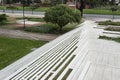 Geometric pattern of a modern white street stairways with green gardens