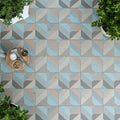 Geometric patterned tiles in blue, grey, and peach create a visually striking floor. Two Royalty Free Stock Photo