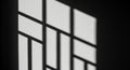Geometric patterns of light and shadow form on a wall, likely from a window with a Royalty Free Stock Photo