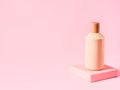 Geometric pink stand podium displaying cosmetic body skin care generic bottle