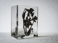 A geometric, rectangular patterned clear glass vase.