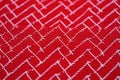 Geometric red fabric with white zigzag pattern texture Royalty Free Stock Photo