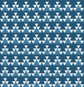 Geometric seamless pattern with white triangular shapes on a teal background