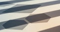 Geometric shadows of hexagons are cast on a smooth, light-colored surface. The Royalty Free Stock Photo