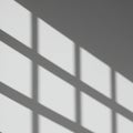 Geometric shadows on a wall form a grid pattern, likely cast by a window or similar Royalty Free Stock Photo