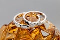 Geometric shape wedding rings on orange background Royalty Free Stock Photo