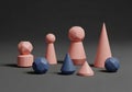 Geometric shapes on a dark surface, featuring light pink and blue objects Royalty Free Stock Photo