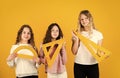 geometric shapes. modern education concept. sisterhood. three girls with protractor and triangle ruler. back to school