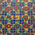 Geometric tile pattern featuring interlocking shapes in blue, green, yellow, Royalty Free Stock Photo