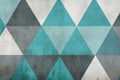 Geometric triangular shapes in gray and turquoise, creating a dynamic, minimalist design with a