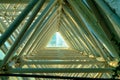 Geometric tunnel with triangular metal beams and scaffolding in greenhouse building or structure with glass Royalty Free Stock Photo