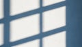 Geometric window shadow patterns cast across a textured white wall in soft natural light Keywords: shadow, light Royalty Free Stock Photo