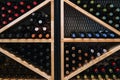 Geometric Wine Rack Filled with Assorted Bottles. Well-stocked wine rack featuring displaying an array of red, white