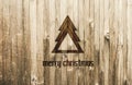 Geometrical Christmas Tree Burned in Wood. Christmas Card with text Merry Christmas.