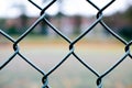 Geometrical grey-green wire fence in close-up at tennis court Royalty Free Stock Photo