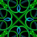 Geometrical pattern made of green blue neon colored curved garlic plants on black