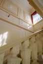 The geometry of a beige staircase with a candlestick in a 19th century mansion Royalty Free Stock Photo