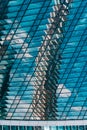 Geometry and lines of a modern business center. Clouds and buildings are reflected in the glass windows of the high-rise Royalty Free Stock Photo