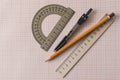 Geometry set with compass,pencil,ruler on graph paper Royalty Free Stock Photo