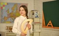 Geometry set. Small child girl holding school protractor for geometry lesson. Learning to use protractor. back to school Royalty Free Stock Photo