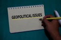 Geopolitical Issues write on a book isolated on Office Desk