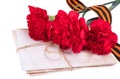 George ribbon with three red carnations bouquet - victory day concept, isolated on white background Royalty Free Stock Photo