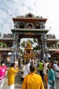 Vertical view of gold chariot arrive archway during Thaipusam