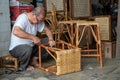 A man repair ratten chair.