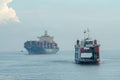 Aerial view ferry move at sea. back is container ship