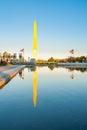 George Washington Memorial obelisk standing proud catching golden rays of sun reflected in calm Reflecting Pool