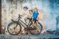 Georgetown, Penang, Malaysia - April 20, 2018: Boy on a bicycle. Public street art Name Children on a bicycle painted 3D