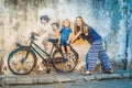 Georgetown, Penang, Malaysia - April 20, 2018: Mother and son on a bicycle. Public street art Name Children on a bicycle