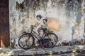 Georgetown, Penang, Malaysia - April 20, 2018: Public street art Name Children on a bicycle painted 3D on the wall that