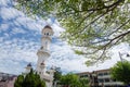 Minaret Kapitan Keling Mosque with green leaves.