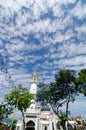 Minaret Kapitan Keling Mosque under blue sky.